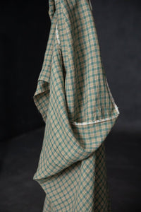 A green and pink laundered linen check fabric