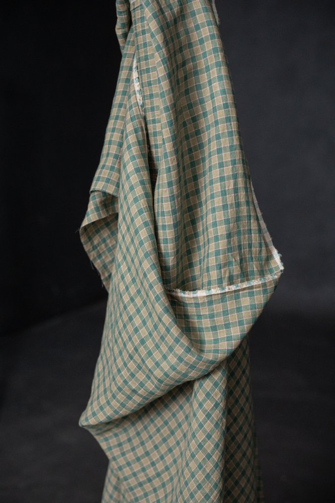 A green and pink laundered linen check fabric